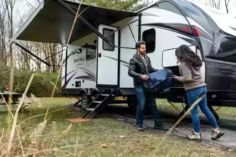 rv lifestyle - couple packing rv for a road trip with an rv road trip checklist